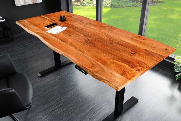 Live edge solid wood ergonomic height adjustable table with black metal legs in a modern office setting
