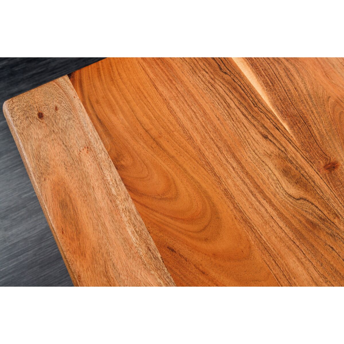 Close-up of a Wooden electric adjstable desk  with a dark surface underneath